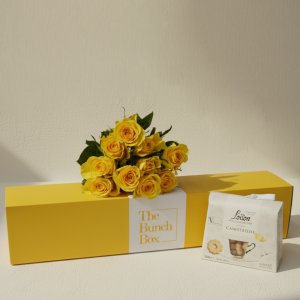 The Yellow Rose Tea Party Pack features ten radiant yellow roses paired with 200g of artisanal Loison Canestrello biscuits. Presented in a color-matched signature yellow gift box, this set offers a professional and spirited gifting solution that blends high-end floristry with the heritage of premium Italian confectionery. It is a sophisticated way to share a moment of joy and refined taste.